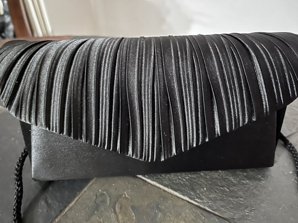 Modern, Sleek designer Clutch by Jessica McClintock. Snag It Fast, It Won’t Last